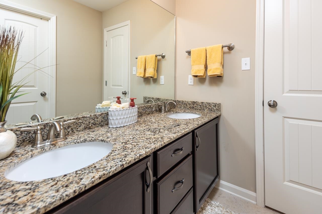 771 Six Oaks Lane Collierville, TN 38017 - Photo 18 of 25 a bathroom with a granite countertop sink and a mirror