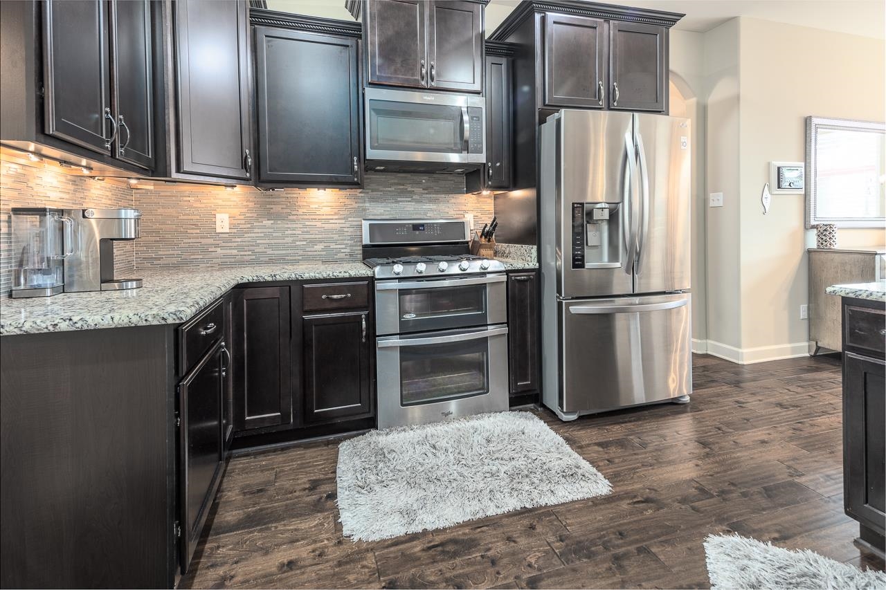 771 Six Oaks Lane Collierville, TN 38017 - Photo 4 of 25 a kitchen with a refrigerator sink and cabinets