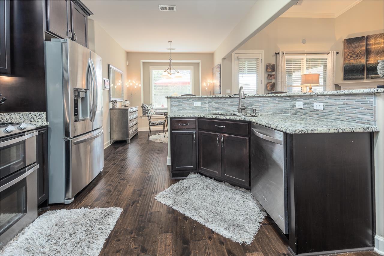 771 Six Oaks Lane Collierville, TN 38017 - Photo 5 of 25 a kitchen with stainless steel appliances granite countertop hardwood a sink stove and refrigerator