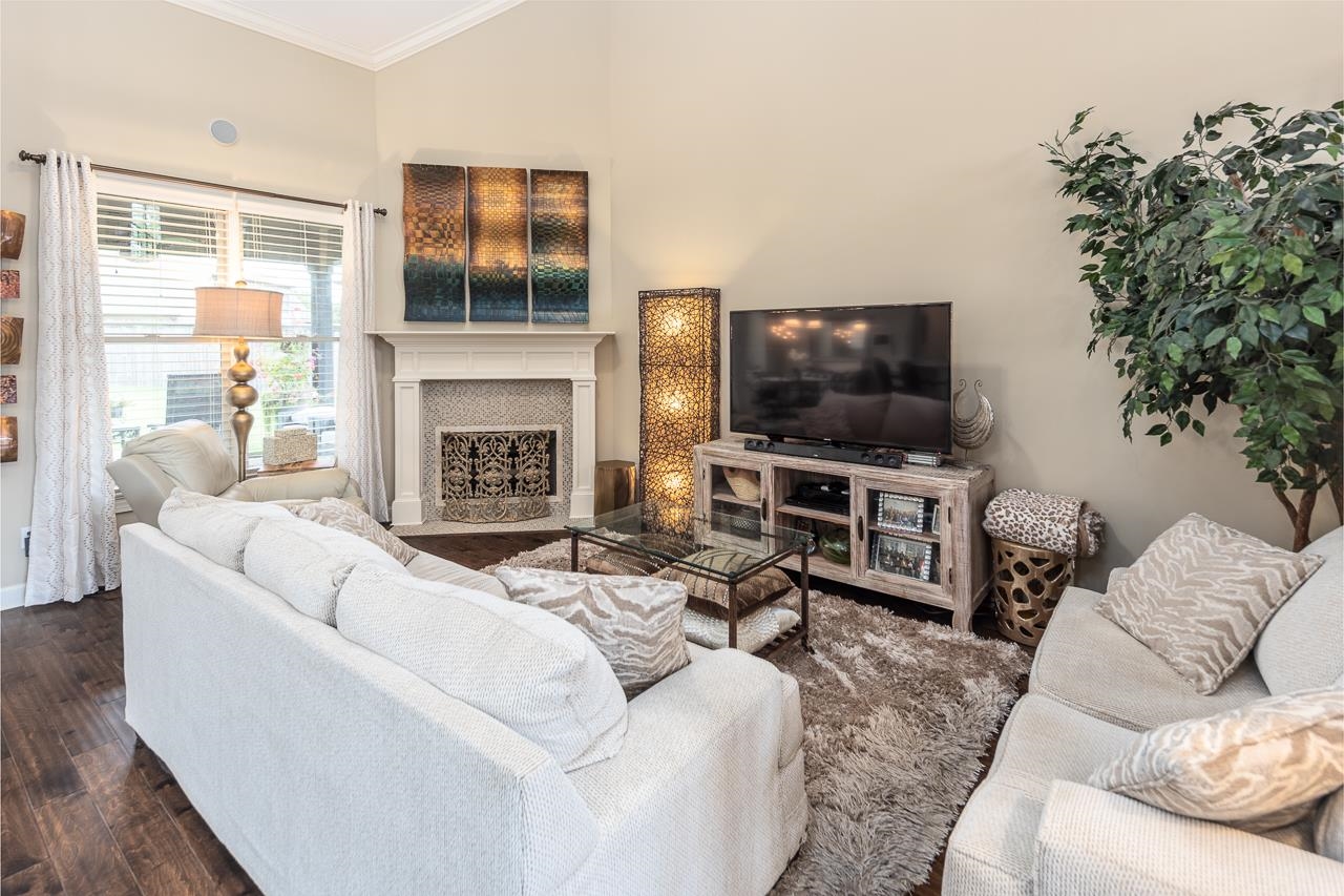 771 Six Oaks Lane Collierville, TN 38017 - Photo 10 of 25 a living room with furniture a fireplace and a flat screen tv