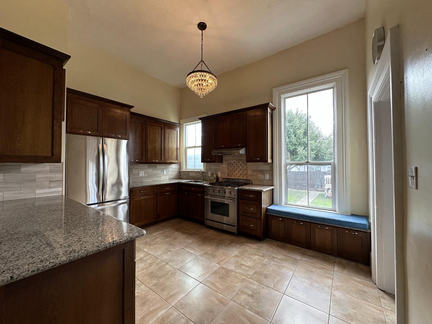 69 Geil Street Salinas, CA 93901 - Photo 13 of 34 a large kitchen with a large counter top appliances and cabinets