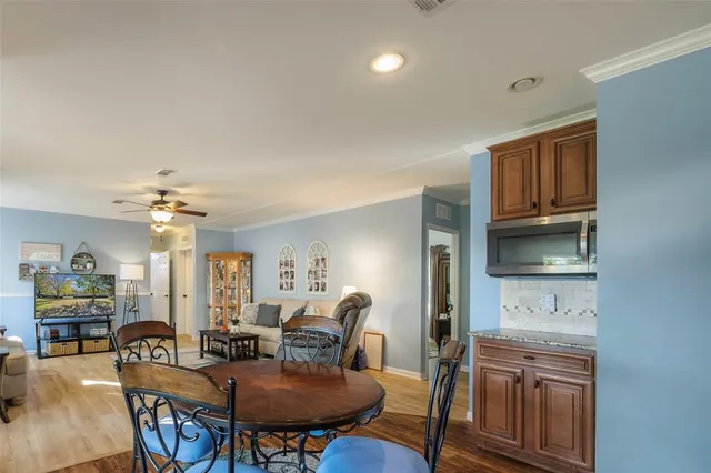 a view of a dining room with furniture and a chandelier