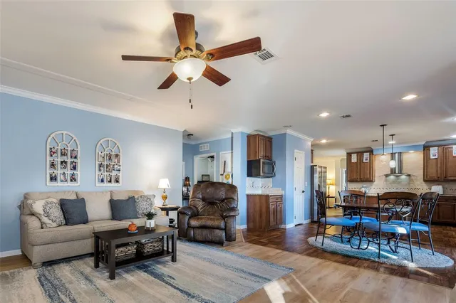 a living room with furniture and kitchen view