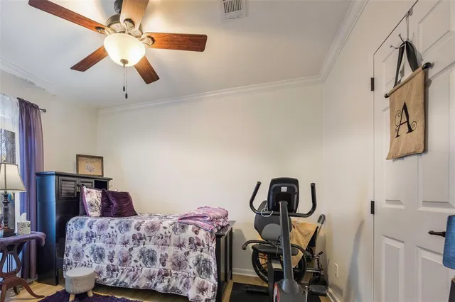 a bedroom with furniture and a ceiling fan