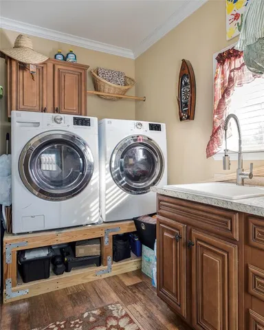 a utility room with sink dryer and washer