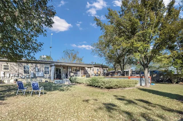 a view of backyard with patio