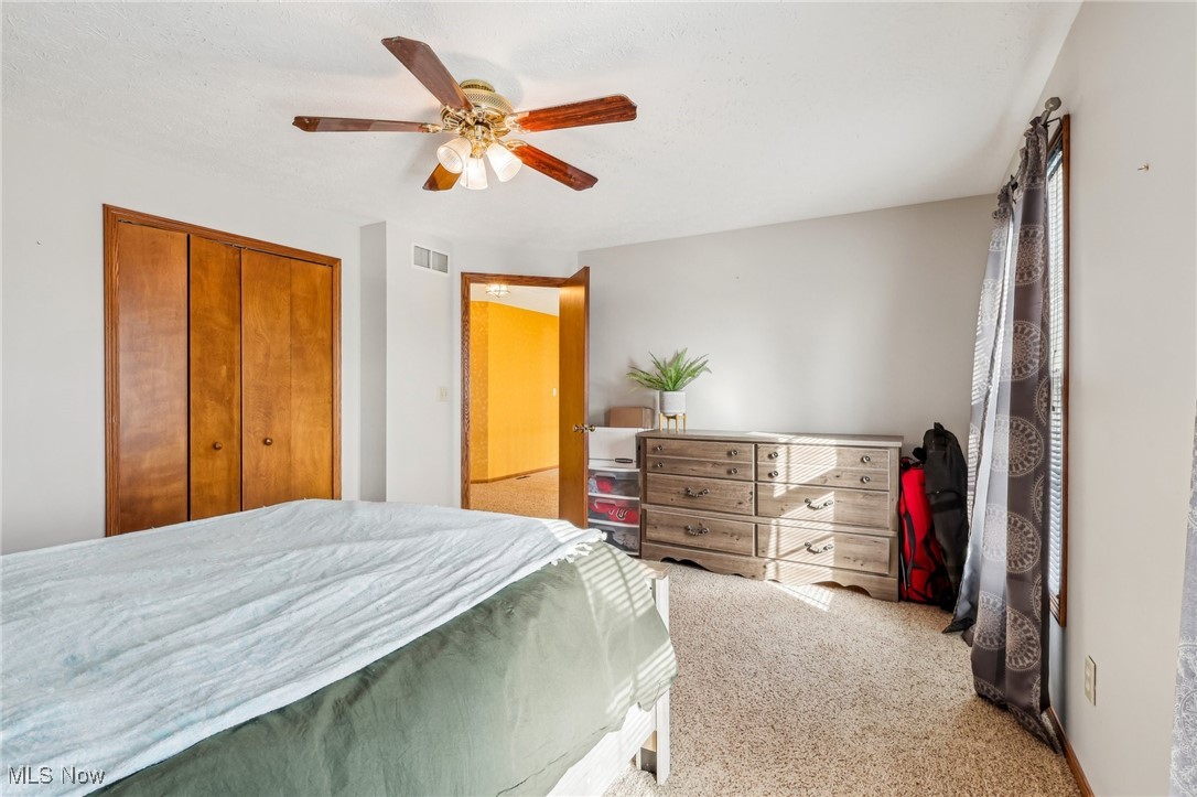 3530 State Road Medina, OH 44256 - Photo 31 of 47 Bedroom featuring light colored carpet, a closet, and ceiling fan