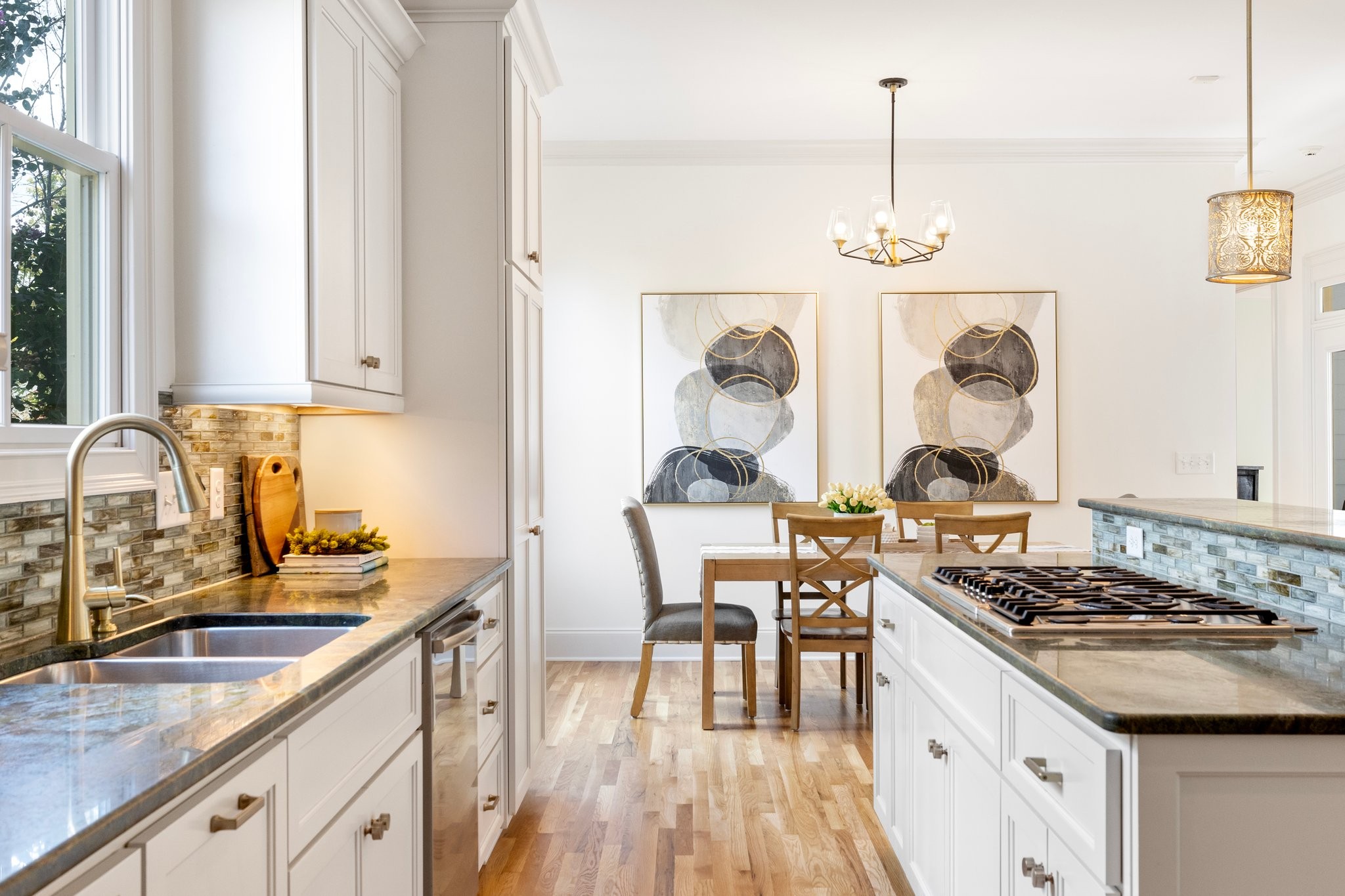 2019 Tabitha Drive Franklin, TN 37064 - Photo 18 of 69 a kitchen with stainless steel appliances granite countertop a stove a sink dishwasher and white cabinets with wooden floor