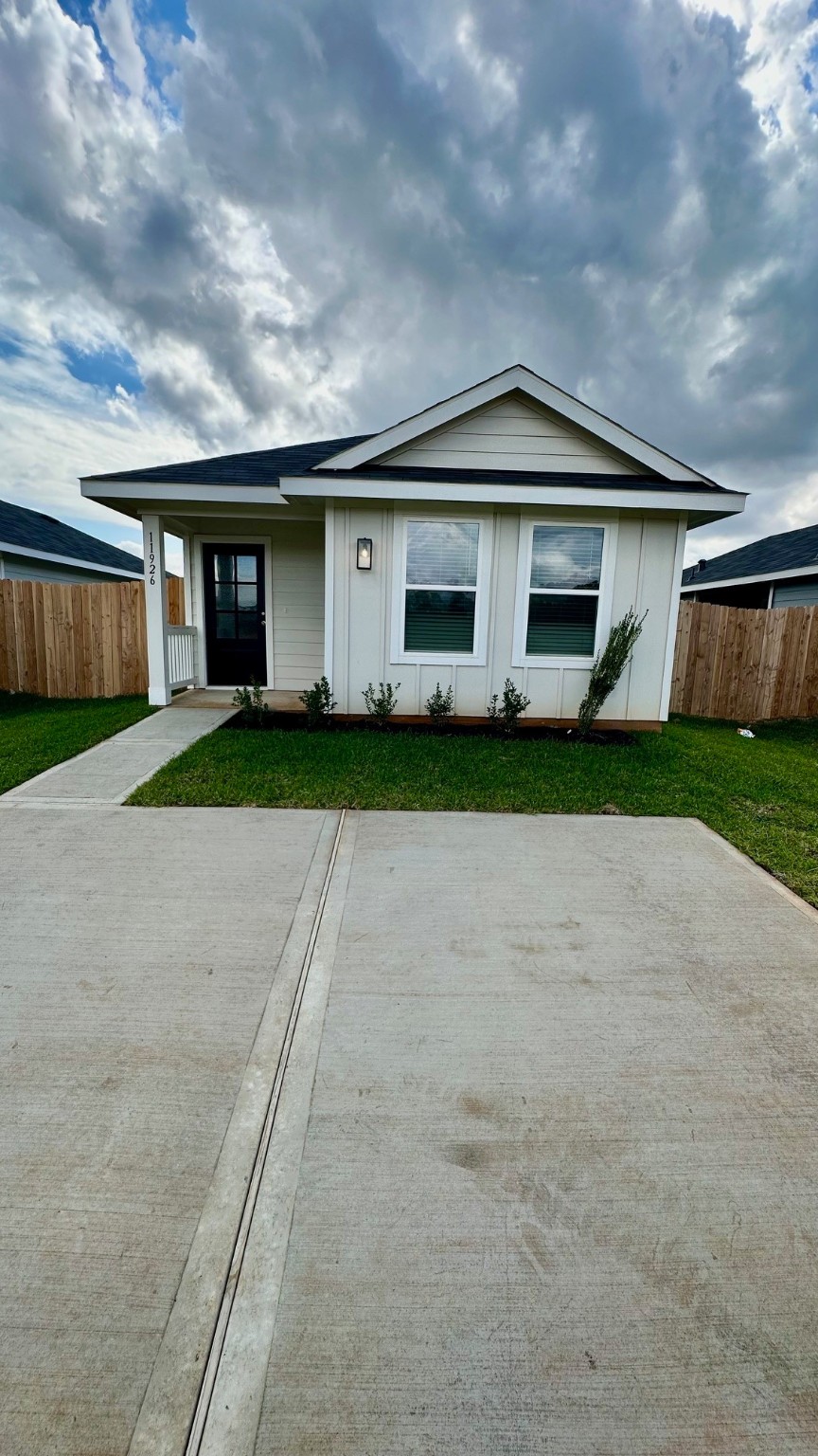 a front view of house with yard and trees