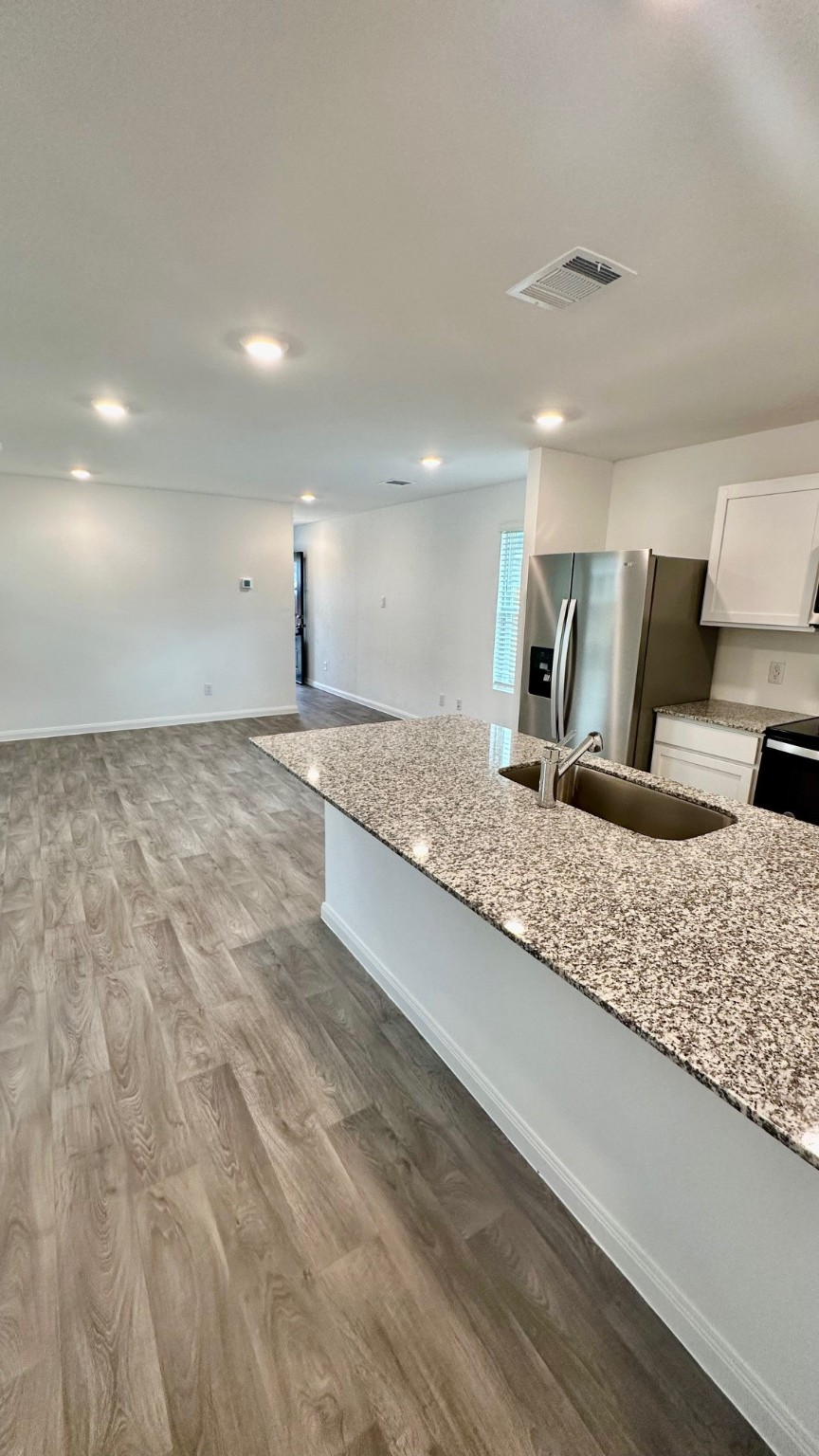 11926 Midas Lane Willis, TX 77378 - Photo 14 of 28 a large white kitchen with a sink and a stove