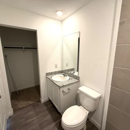 a bath tub sitting next to a white toilet