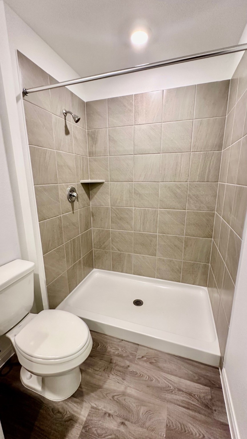 11926 Midas Lane Willis, TX 77378 - Photo 17 of 28 a bathroom with a bathtub and a shower