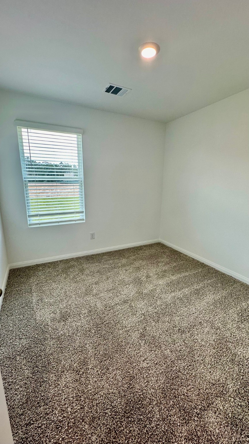 11926 Midas Lane Willis, TX 77378 - Photo 21 of 28 an empty room with a empty space and windows