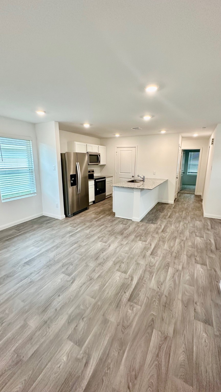 11926 Midas Lane Willis, TX 77378 - Photo 8 of 28 a large room with a bed and a view of kitchen