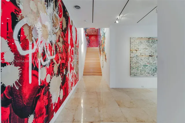 a living room with furniture and a book shelf
