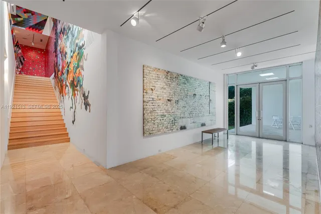 a view of a livingroom with furniture and a large window
