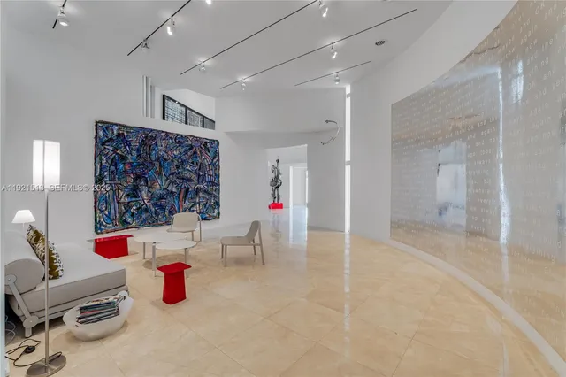 a living room with furniture and a painting on the wall