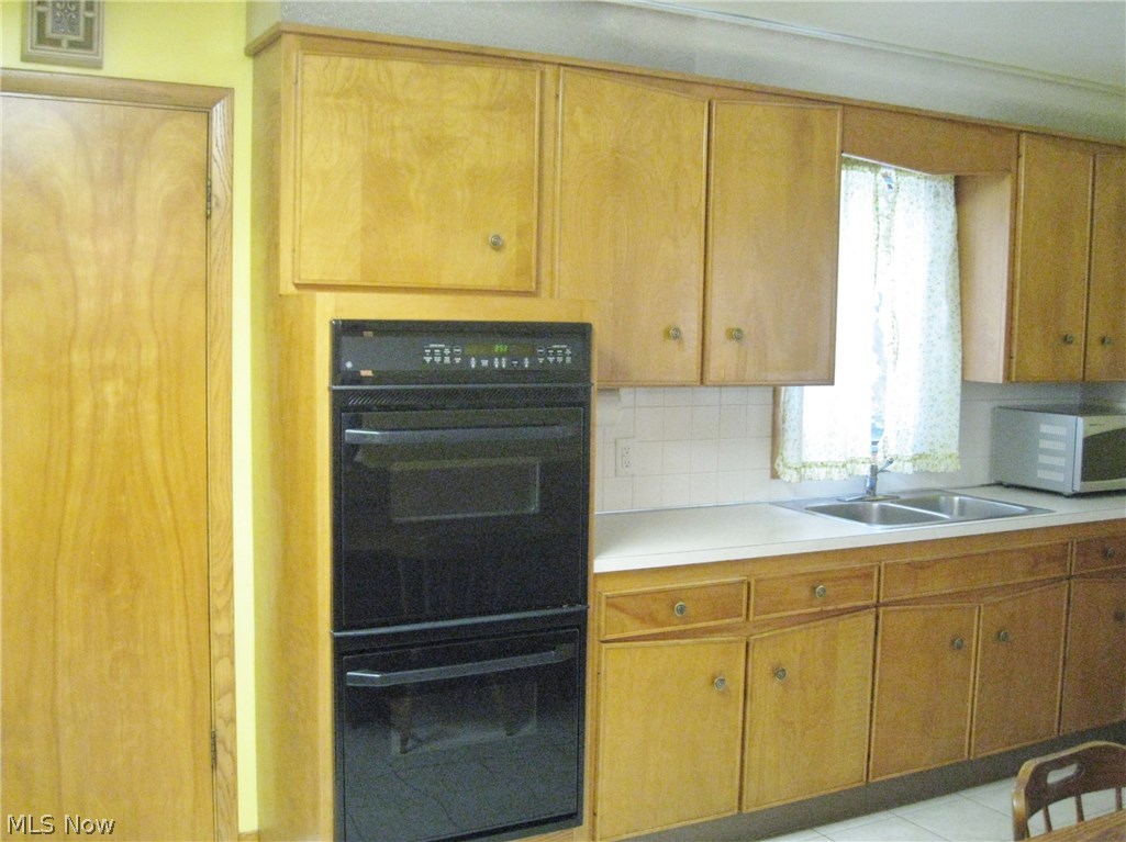 105 Trunko Road Akron, OH 44333 - Photo 10 of 21 Kitchen. Double GE Ovens. All appliances remain. Entrance to garage on left.