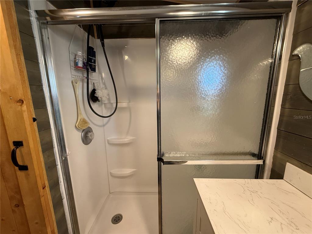 9408 Cougar Drive Weeki Wachee, FL 34613 - Photo 12 of 27 a bathroom with a shower