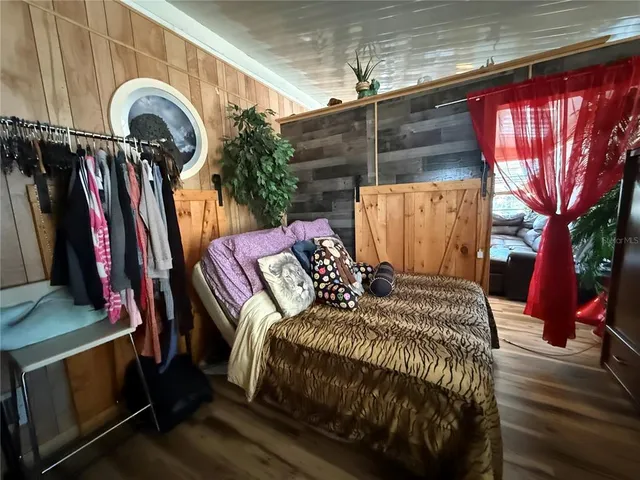 a bedroom with a bed and a mirror