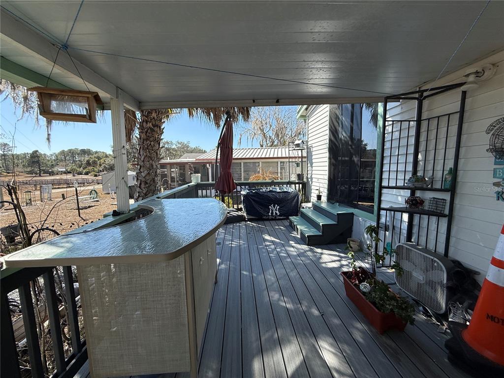 9408 Cougar Drive Weeki Wachee, FL 34613 - Photo 17 of 27 a view of a living room and kitchen floor to ceiling window and wooden floor