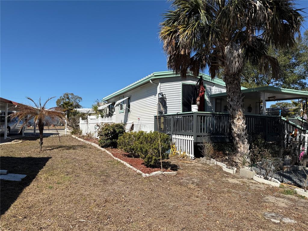 9408 Cougar Drive Weeki Wachee, FL 34613 - Photo 20 of 27 a front view of a house with a yard and garage