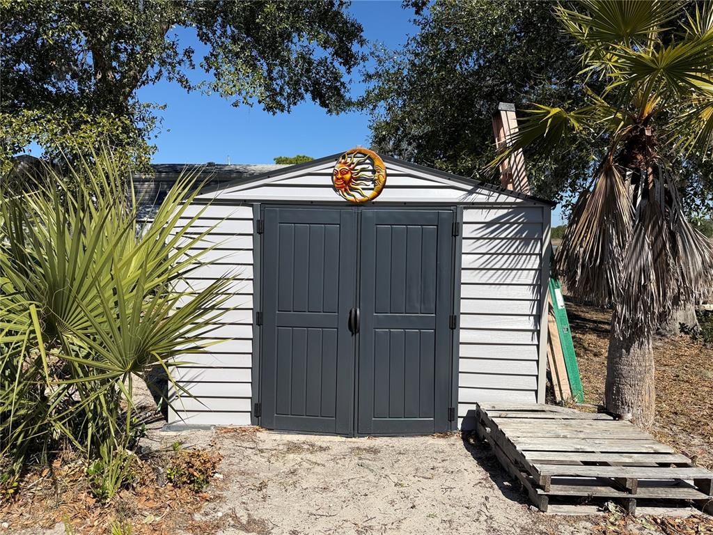 9408 Cougar Drive Weeki Wachee, FL 34613 - Photo 22 of 27 a view of a backyard with a small cabin
