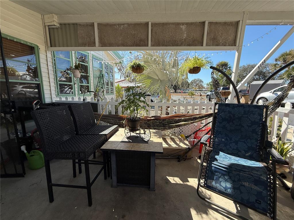 9408 Cougar Drive Weeki Wachee, FL 34613 - Photo 25 of 27 a outdoor living room with a couch and a table