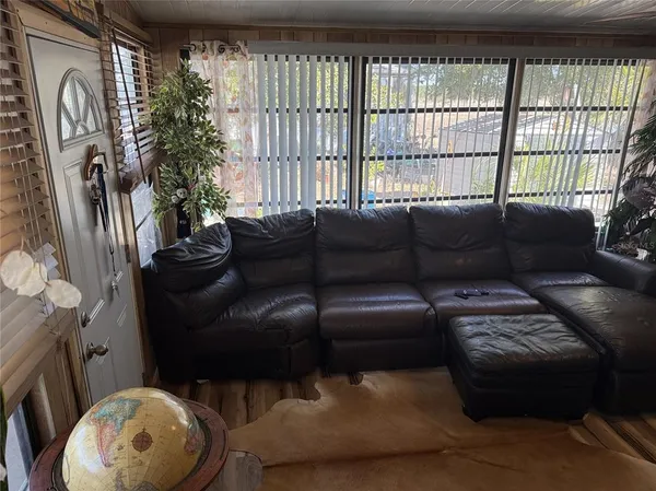 a living room with furniture and a floor to ceiling window