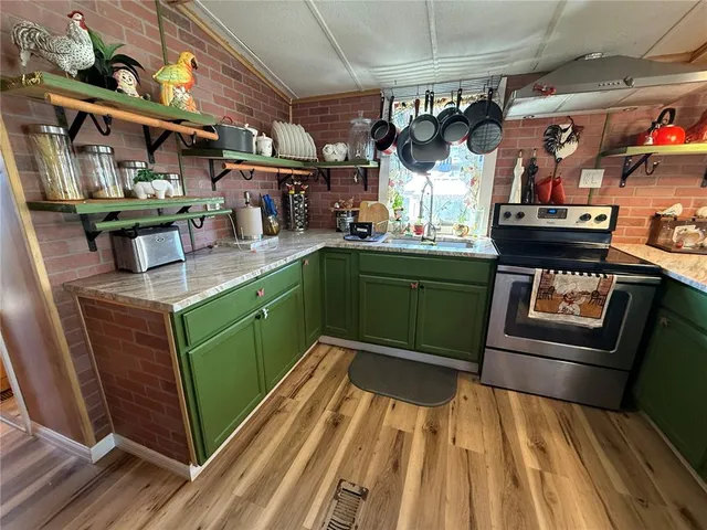 a kitchen with lots of wooden cabinets and stainless steel appliances