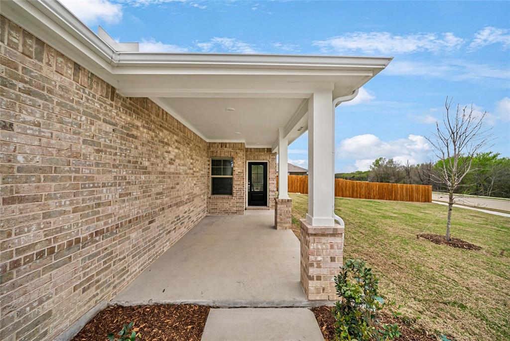 417 Martell Road Lowry Crossing, TX 75069 - Photo 5 of 29 a view of a porch with a table and chair