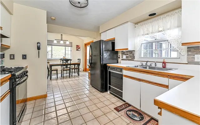 a kitchen with stainless steel appliances a sink a counter top space and cabinets