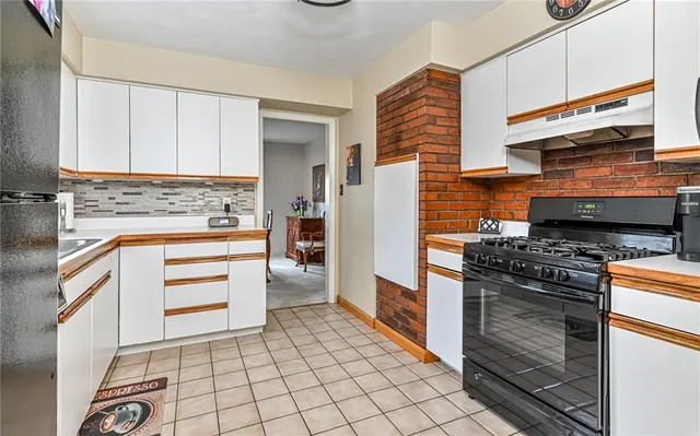 a kitchen with a stove and a cabinets