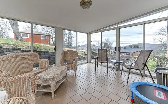 a living room with furniture and a floor to ceiling window