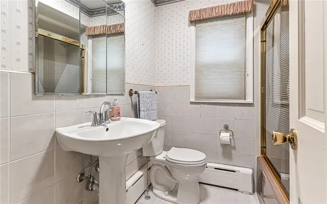 a bathroom with a sink toilet and mirror