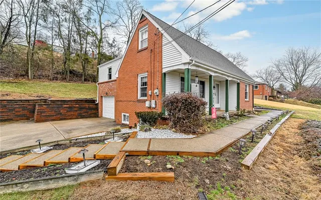 a view of a house with backyard and sitting area