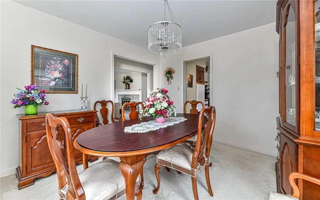a dining room with furniture and chandelier