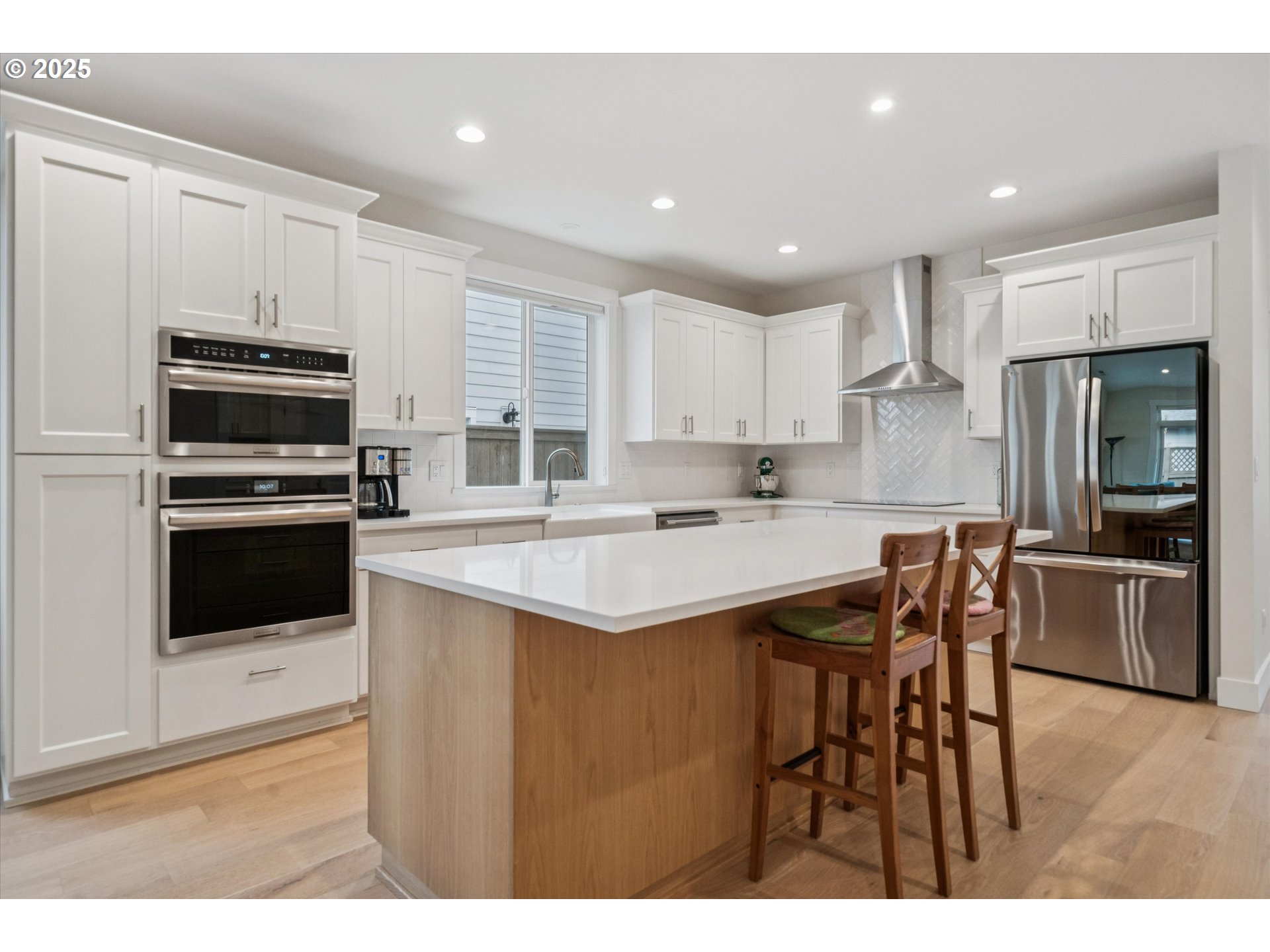 224 Southwest 18th Avenue Canby, OR 97013 - Photo 13 of 40 a kitchen with stainless steel appliances kitchen island granite countertop a table chairs microwave and sink