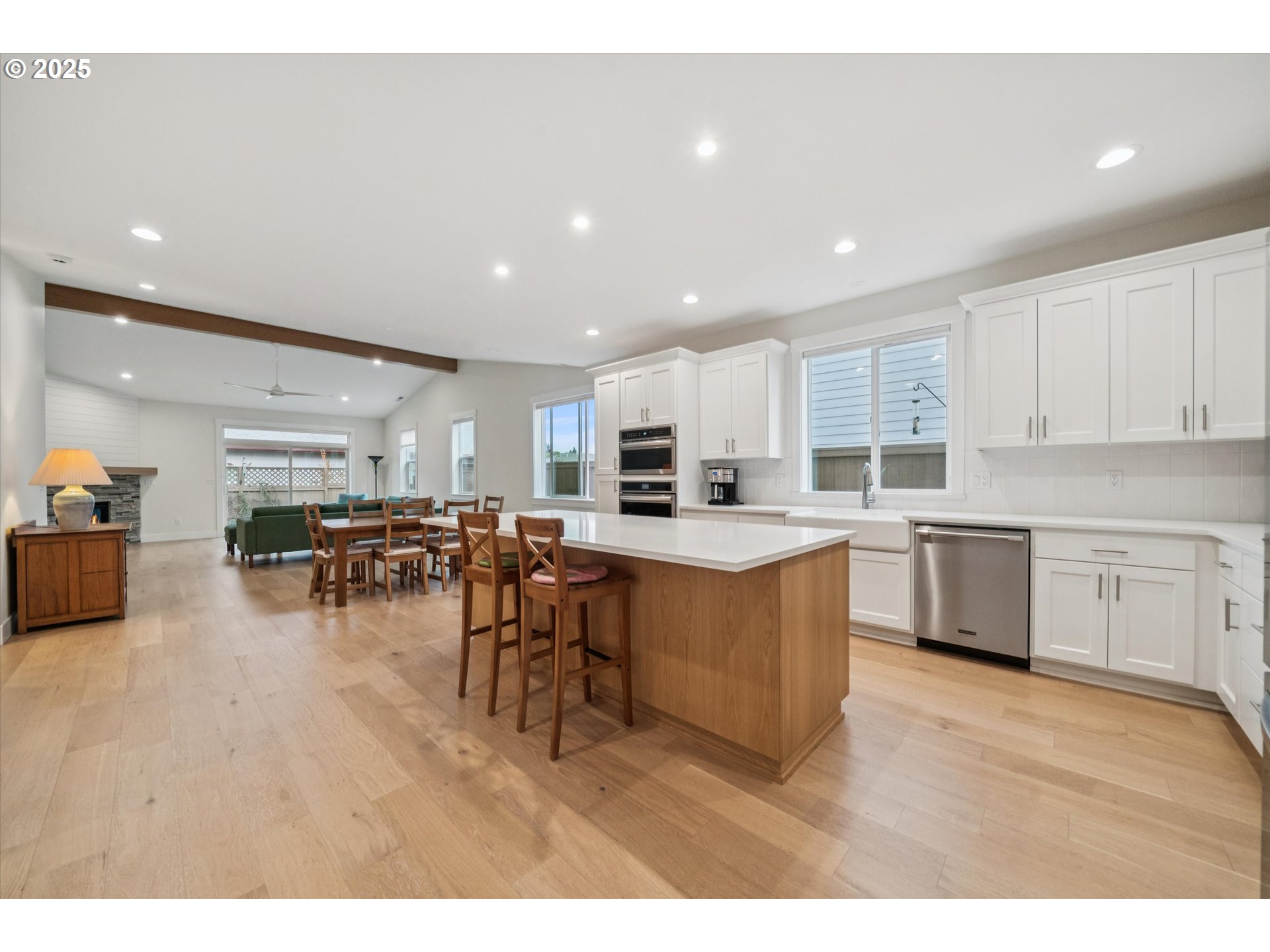 224 Southwest 18th Avenue Canby, OR 97013 - Photo 14 of 40 a kitchen with stainless steel appliances lots of white cabinets a sink dishwasher and a stove with wooden floor