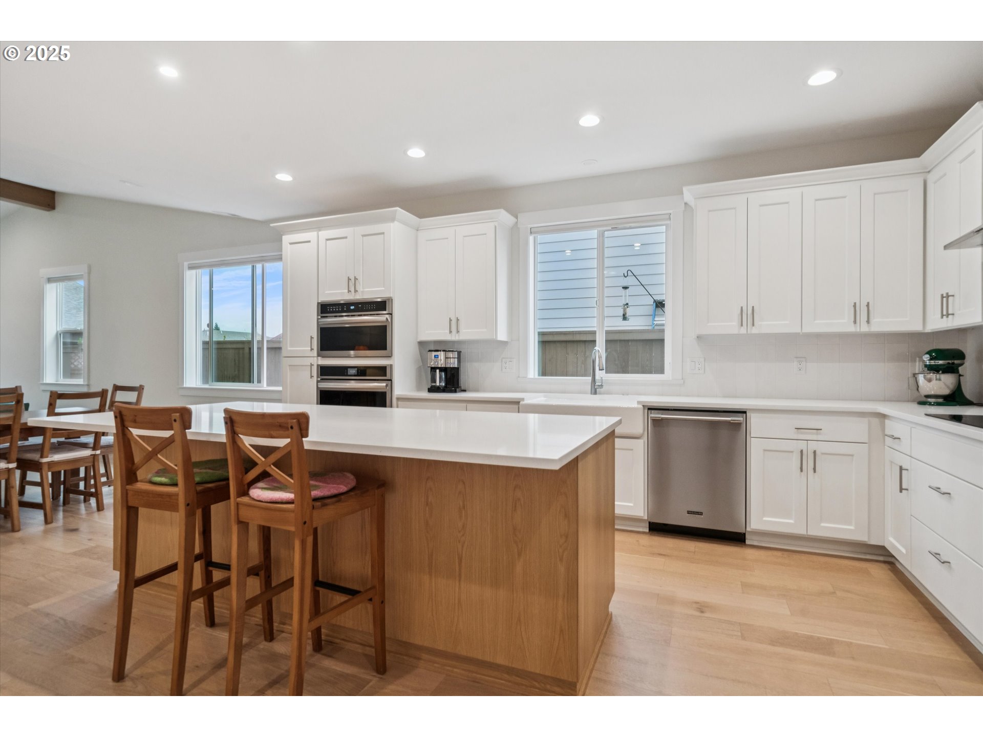 224 Southwest 18th Avenue Canby, OR 97013 - Photo 15 of 40 a kitchen with stainless steel appliances granite countertop a stove top oven a sink dishwasher a dining table and chairs with wooden floor