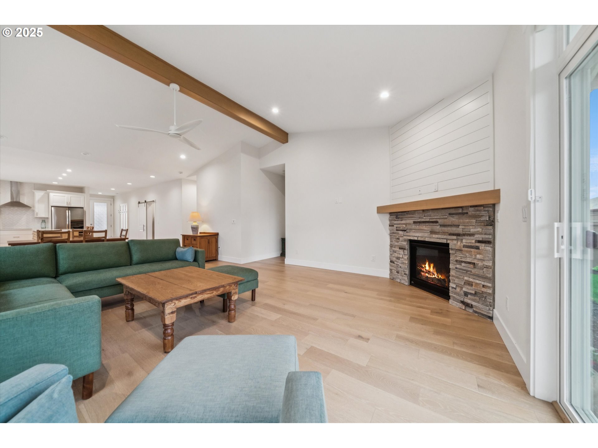 224 Southwest 18th Avenue Canby, OR 97013 - Photo 7 of 40 a living room with furniture a fireplace and kitchen view