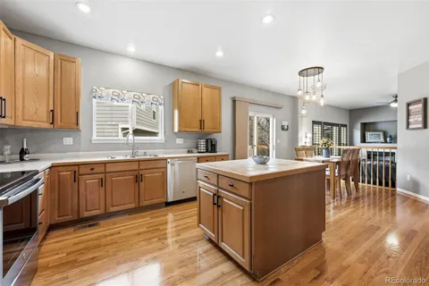 a kitchen with sink stove and cabinets