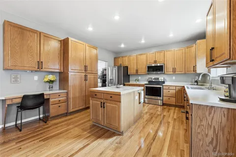 a kitchen with stainless steel appliances granite countertop a refrigerator stove microwave and sink