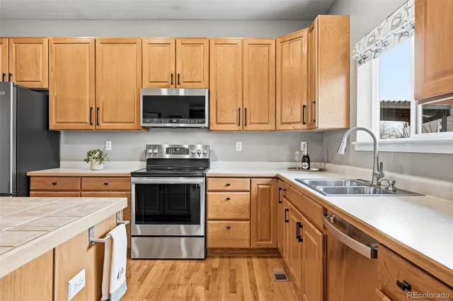 a kitchen with a sink stove and cabinets