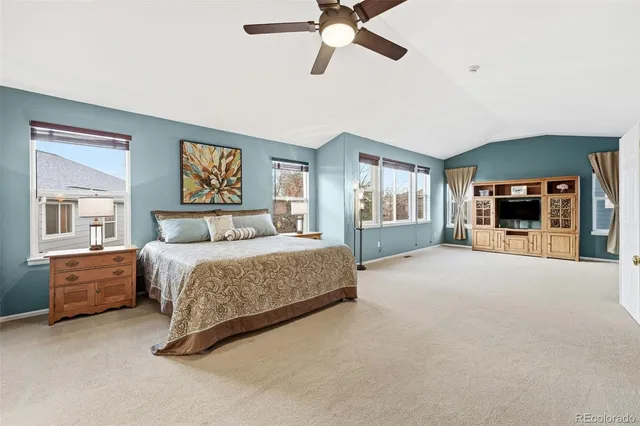 a bedroom with a large bed and a tv