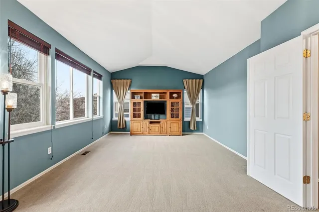 a big room with windows and a fireplace