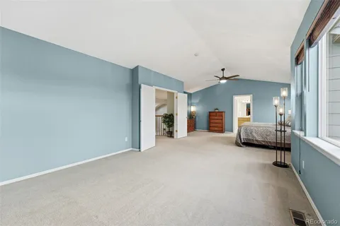 a view of a bedroom with furniture and a window