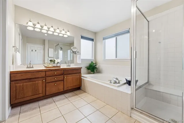 a spacious bathroom with a granite countertop sink a mirror and a