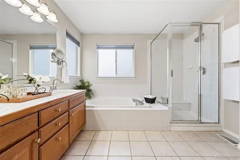 a bathroom with a tub a sink and a mirror