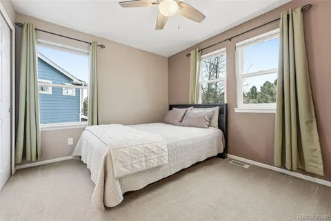 a bed sitting in a bedroom next to a window
